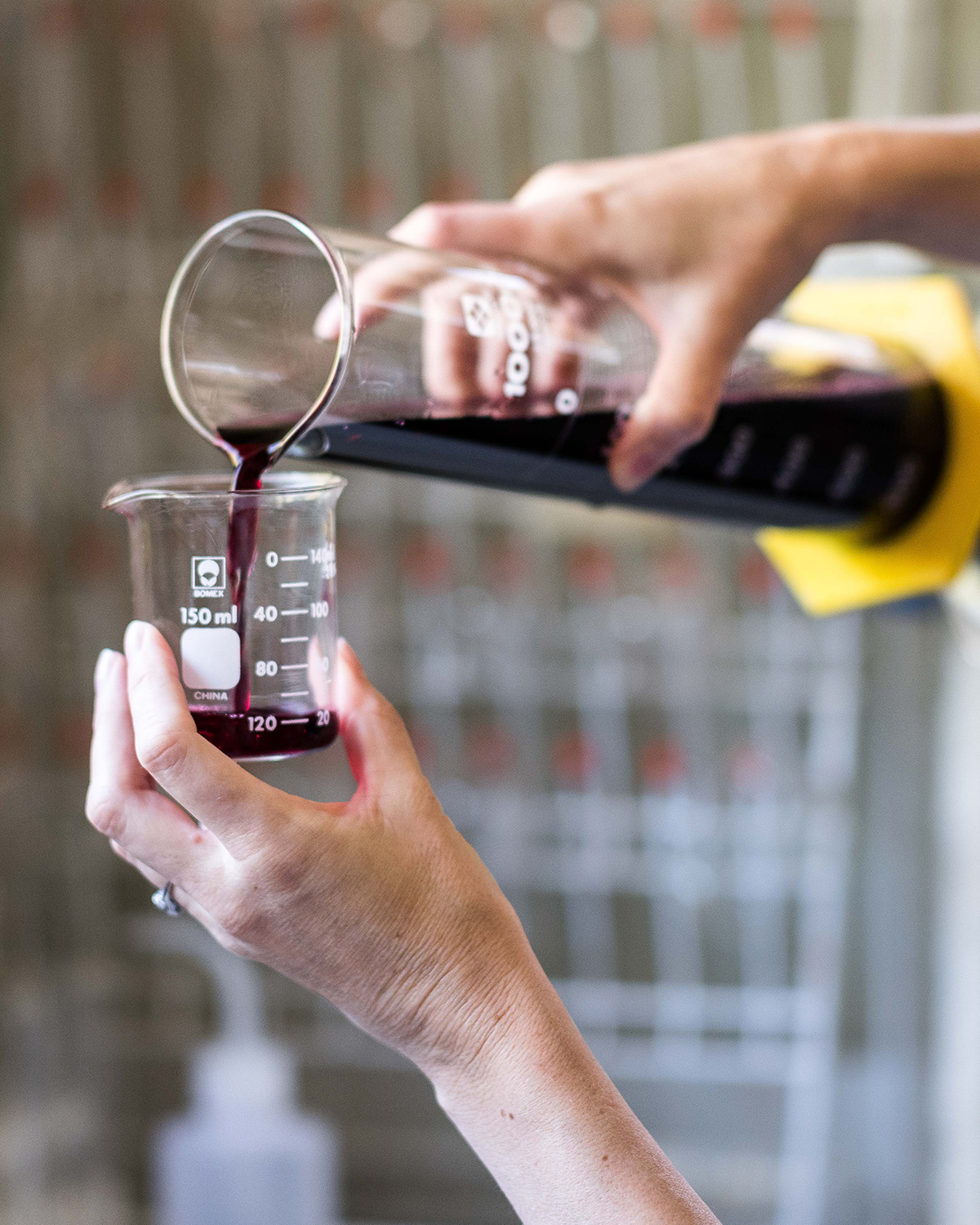 Rm Winery's wine maker testing batch of wine